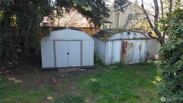 view of shed featuring fence