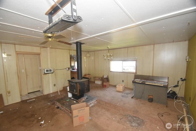 basement with ceiling fan and a wood stove