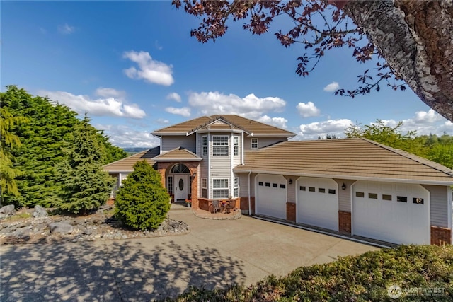 5801 51st Avenue Ct E, Tacoma, WA 98443 - view of front of house with an attached garage, driveway, and brick siding
