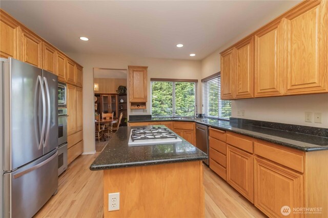 5801 51st Avenue Ct E, Tacoma, WA 98443 - kitchen featuring a center island, dark stone counters, light wood-style flooring, and appliances with stainless steel finishes