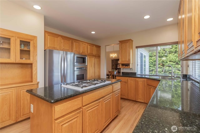 5801 51st Avenue Ct E, Tacoma, WA 98443 - kitchen featuring appliances with stainless steel finishes, a sink, dark stone countertops, a kitchen island, and glass insert cabinets