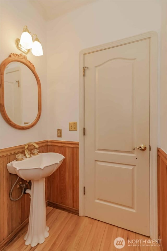 5801 51st Avenue Ct E, Tacoma, WA 98443 - bathroom featuring wood finished floors and a wainscoted wall
