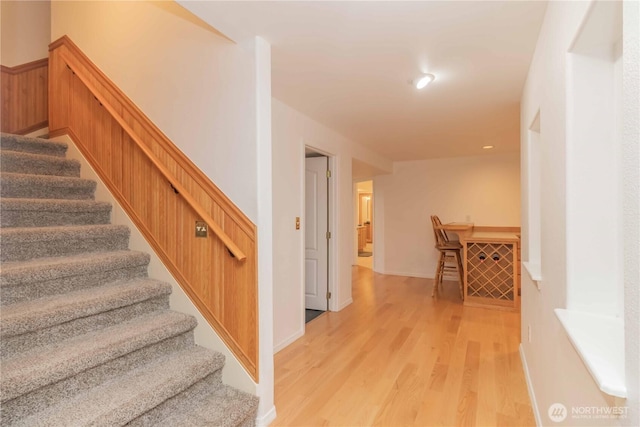 5801 51st Avenue Ct E, Tacoma, WA 98443 - stairway featuring wainscoting and wood finished floors