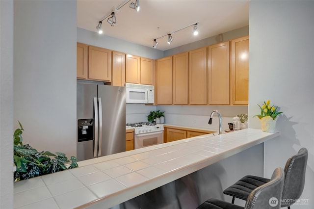 109 2nd St S Unit 523, Kirkland, WA 98033 - kitchen with light brown cabinetry, tile countertops, and white appliances