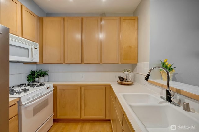 109 2nd St S Unit 523, Kirkland, WA 98033 - kitchen featuring a sink, light brown cabinets, white appliances, light countertops, and backsplash