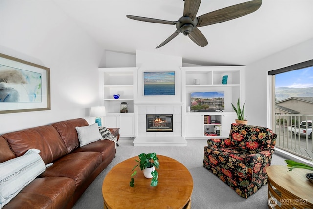 351 19th St NE Unit 10, East Wenatchee, WA 98802 - living area featuring a tiled fireplace, carpet, ceiling fan, and lofted ceiling