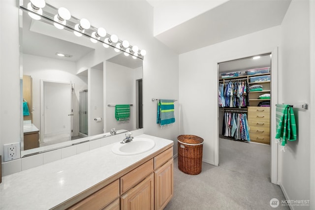 351 19th St NE Unit 10, East Wenatchee, WA 98802 - full bath featuring vanity, baseboards, a walk in closet, and a shower