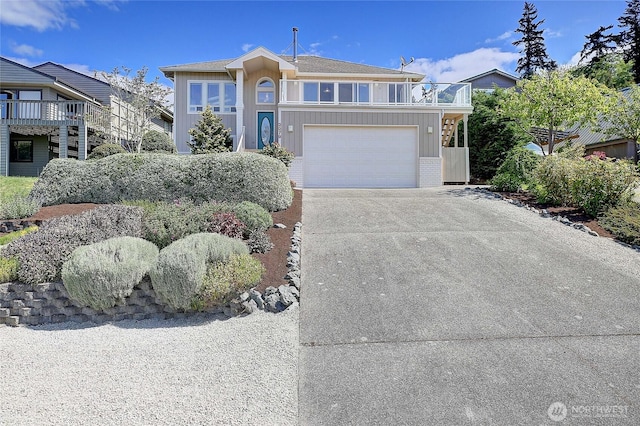 2279 Elger Park Rd, Camano Island, WA 98282 - view of front property with concrete driveway, a balcony, board and batten siding, and a garage