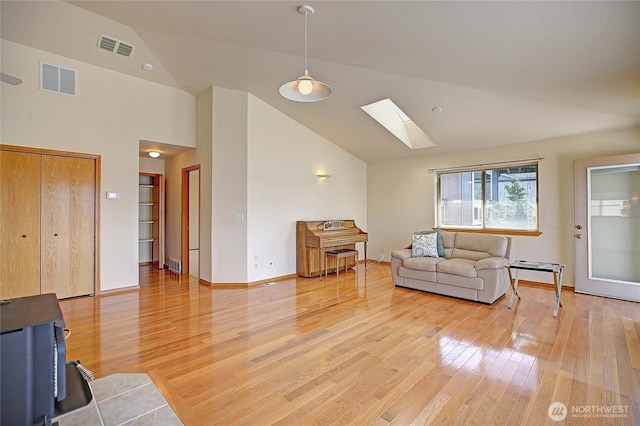 2279 Elger Park Rd, Camano Island, WA 98282 - living area with a skylight, lofted ceiling, light wood-style flooring, and baseboards