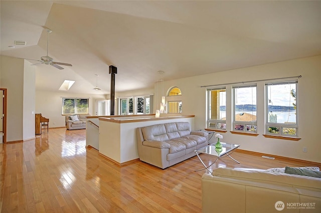 2279 Elger Park Rd, Camano Island, WA 98282 - living room with a ceiling fan, light wood-type flooring, vaulted ceiling, and baseboards