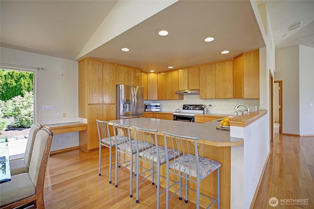 2279 Elger Park Rd, Camano Island, WA 98282 - kitchen with stainless steel fridge, range with electric cooktop, under cabinet range hood, light wood-style flooring, and recessed lighting