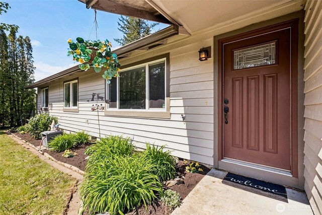 entrance to property featuring cooling unit