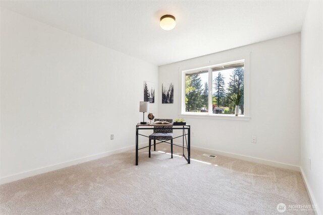 office space featuring visible vents, carpet flooring, and baseboards