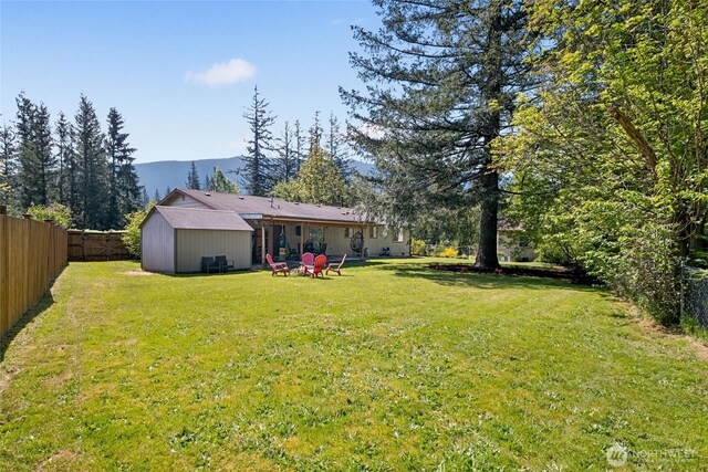 exterior space featuring a fenced backyard and a mountain view