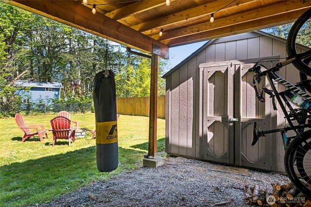 view of shed featuring fence