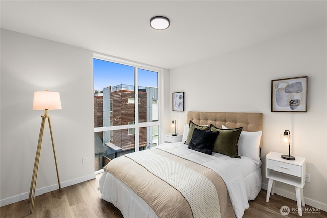 1124C 13th Ave, Seattle, WA 98122 - bedroom with a wall of windows, wood finished floors, and baseboards