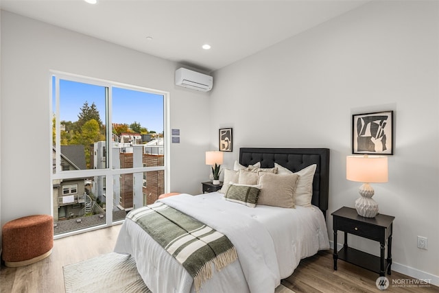 1124C 13th Ave, Seattle, WA 98122 - bedroom with an AC wall unit, wood finished floors, recessed lighting, and baseboards