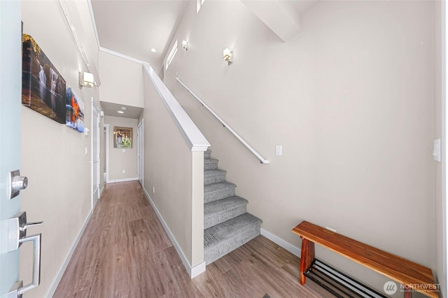 stairway with baseboards and wood finished floors