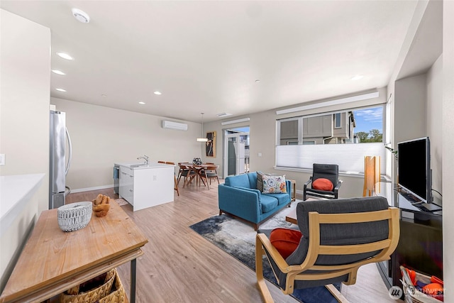living room with light wood-style flooring, recessed lighting, and a wall mounted air conditioner