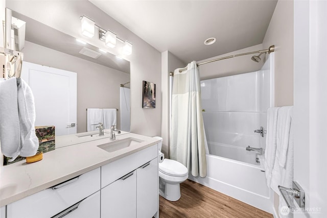 bathroom with vanity, shower / tub combo with curtain, wood finished floors, and toilet