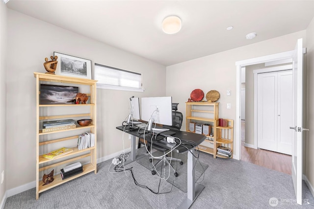 carpeted home office with baseboards