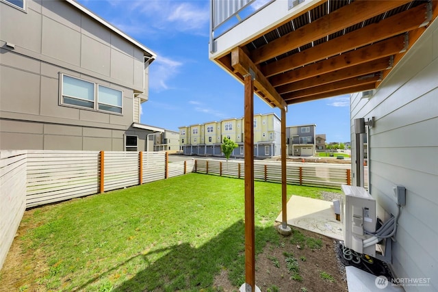 view of yard with a fenced backyard, ac unit, and a residential view