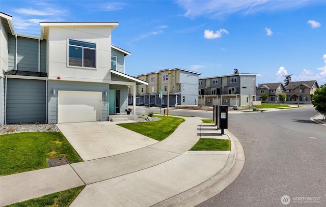 view of front facade featuring a garage, a residential view, and concrete driveway