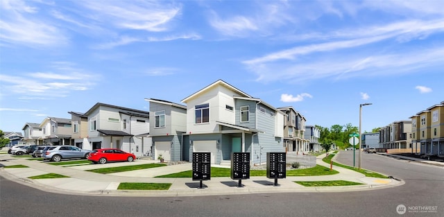 view of front of property featuring driveway, a residential view, and a garage