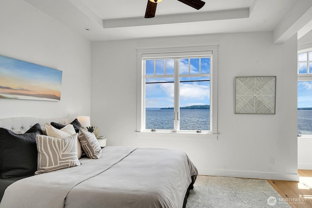 3122 SW 172nd St, Burien, WA 98166 - bedroom featuring a raised ceiling, wood finished floors, and a water view