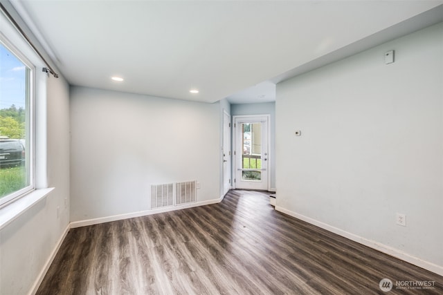 spare room featuring baseboards, recessed lighting, wood finished floors, and visible vents