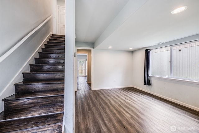 staircase with baseboards, recessed lighting, wood finished floors, and visible vents