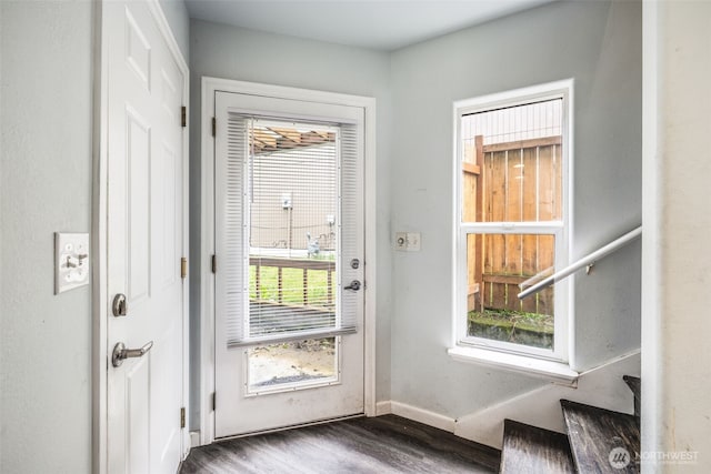 entryway featuring baseboards and wood finished floors
