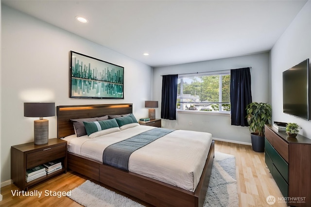 bedroom with recessed lighting, baseboards, and light wood finished floors
