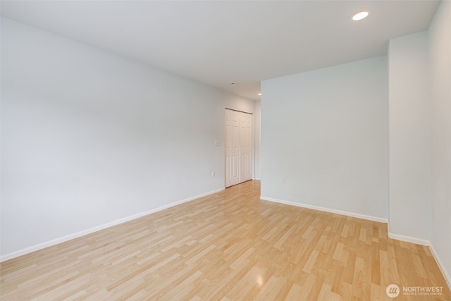 unfurnished room with recessed lighting, baseboards, and light wood finished floors