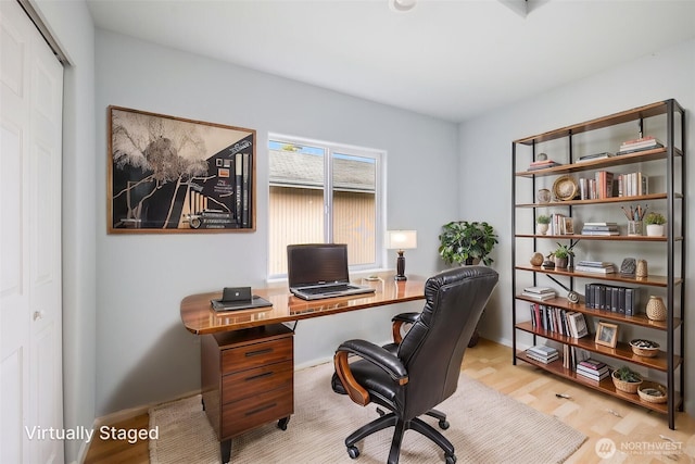 office featuring baseboards and wood finished floors