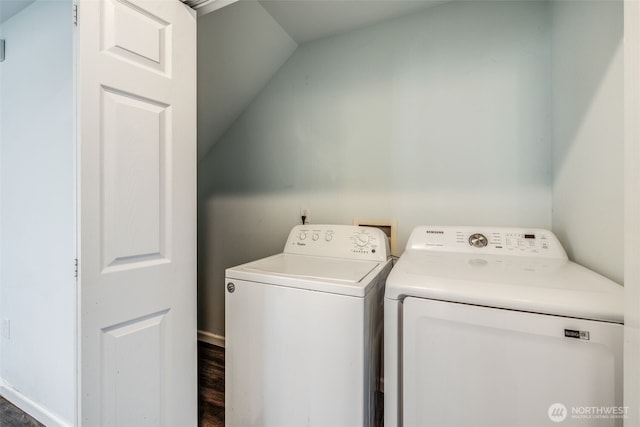 washroom with separate washer and dryer, laundry area, dark wood-style flooring, and baseboards