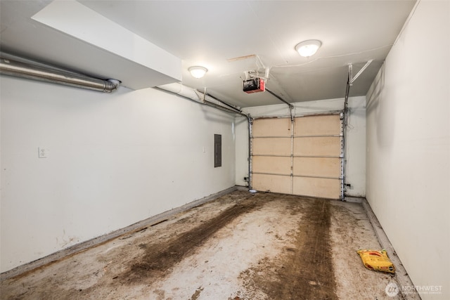 garage with a garage door opener and electric panel