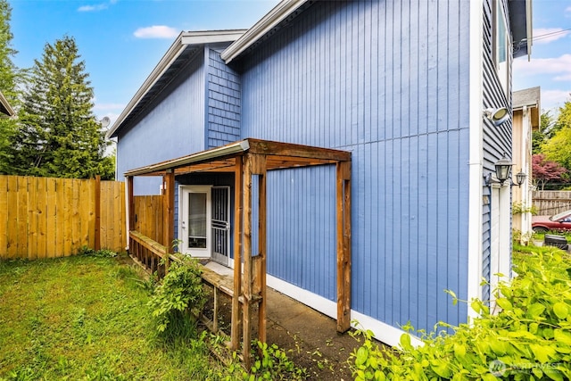 view of side of home featuring fence