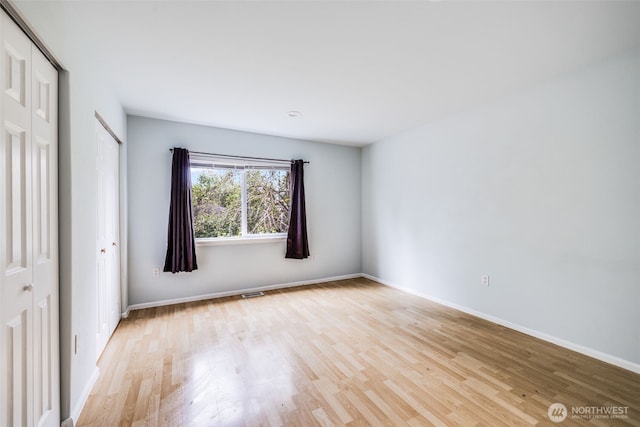 unfurnished bedroom featuring baseboards and light wood finished floors