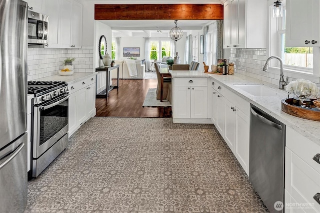 10841 NE 108th St, Kirkland, WA 98033 - kitchen with a chandelier, a sink, beamed ceiling, open floor plan, and stainless steel appliances