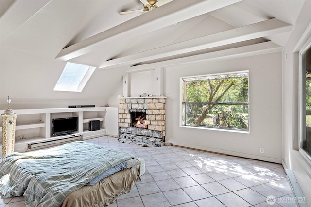 bedroom featuring tile patterned flooring, a stone fireplace, and lofted ceiling with skylight