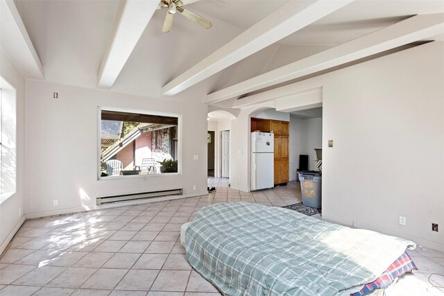 bedroom with freestanding refrigerator, arched walkways, light tile patterned flooring, and baseboard heating