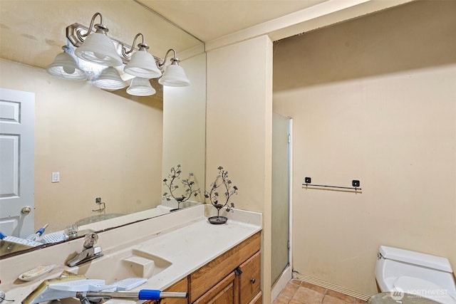 bathroom with an enclosed shower, vanity, tile patterned flooring, and toilet