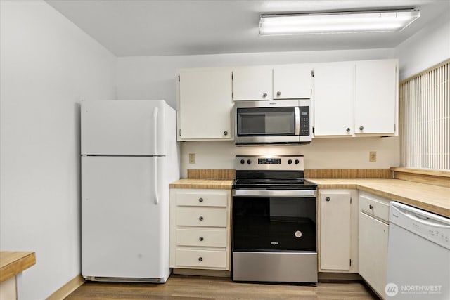 6702 139th Ave NE Unit 742, Redmond, WA 98052 - kitchen featuring light countertops, stainless steel appliances, white cabinets, and light wood-style flooring