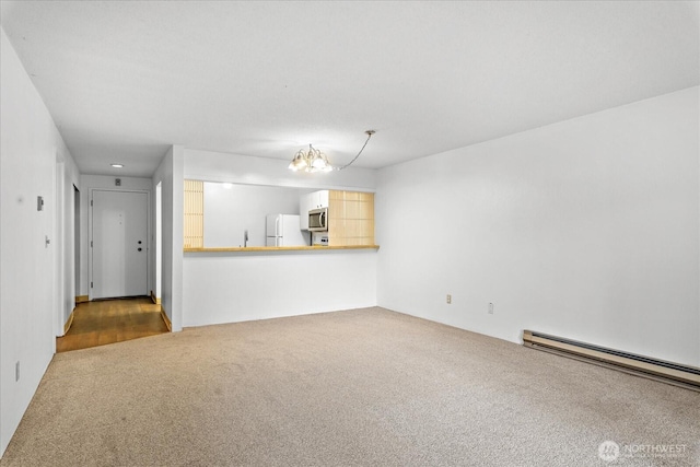 6702 139th Ave NE Unit 742, Redmond, WA 98052 - unfurnished living room featuring carpet, a notable chandelier, and baseboard heating