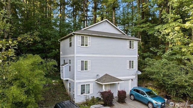 16400 44th Ave W, Lynnwood, WA 98037 - view of home's exterior featuring a shingled roof, an attached garage, and concrete driveway