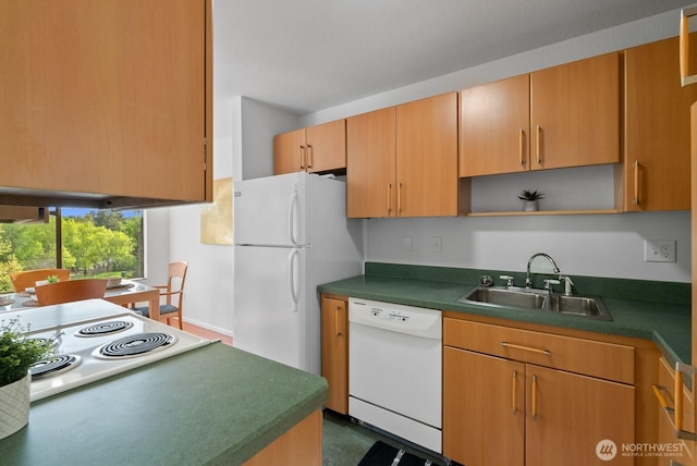 kitchen with white appliances, open shelves, dark countertops, and a sink