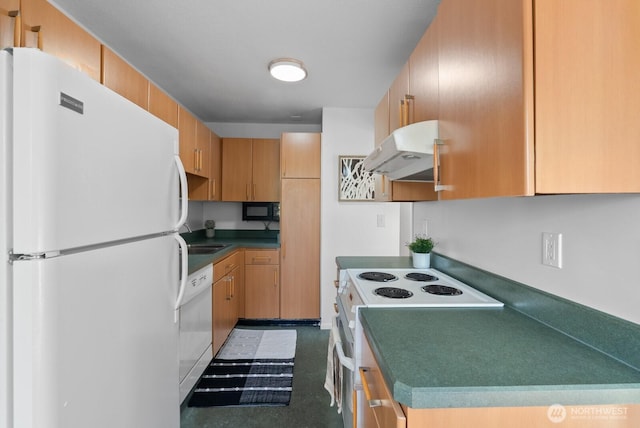kitchen featuring dark countertops, under cabinet range hood, and white appliances