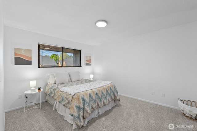 carpeted bedroom featuring baseboards