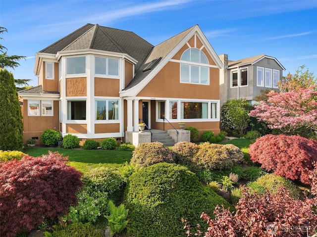 rear view of house featuring stucco siding